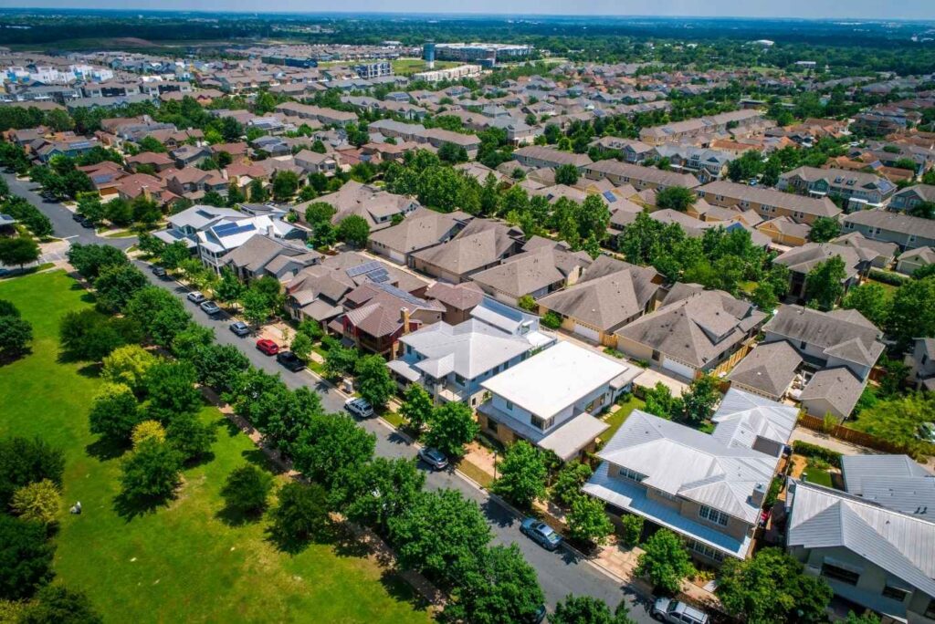 aerial drone view of houses in a line in a neighborhood