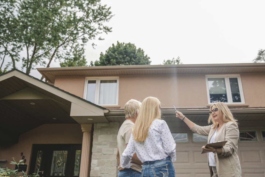 couple in their 50s with a real estate agent looking at a new property to buy